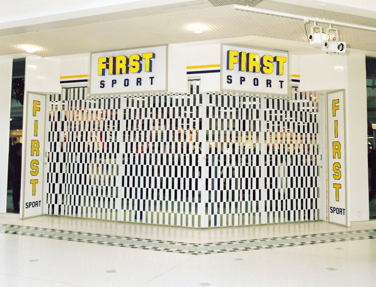 sliding folding aluminium grille in place at First Sport