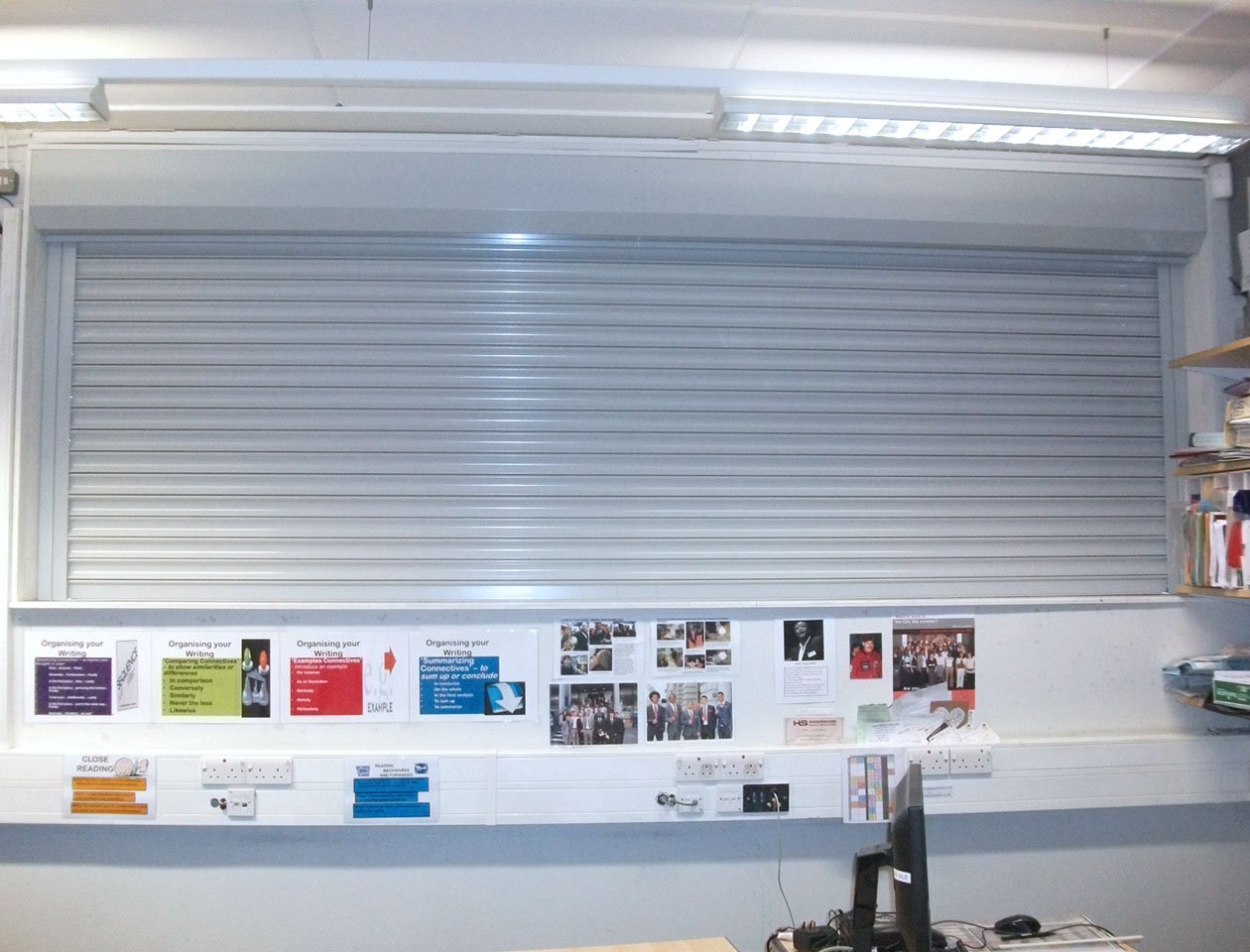 Fire shutter with silver finish in use in hallway